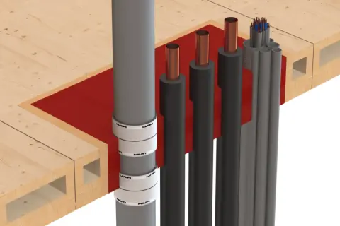 Brandschutz für Rohrleitungen: Hilti-Manschetten sichern Holzdecken gegen Feuer. Mehrere Rohre und Kabel werden durch die Brandschutzmaßnahme geführt.