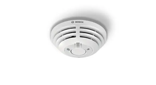 Ein weißer Bosch Smart Home Rauchmelder blinkt rot, was auf eine mögliche Gefahr hinweist.